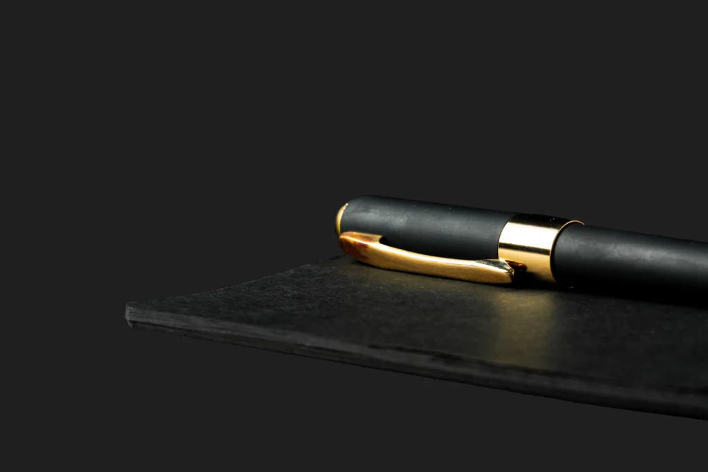 black notepad with pen on black table close up 2025 02 25 03 13 32 utc1